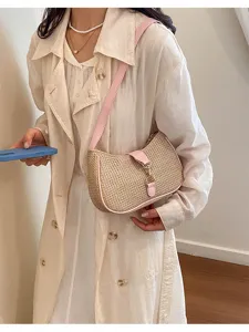 Straw shoulder bag for women, trendy underarm hobo purse with pink leather trim and chic metal lock.