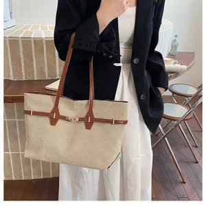 Vintage large canvas tote bag for women, stylish commuting shoulder bag with chic lock design.