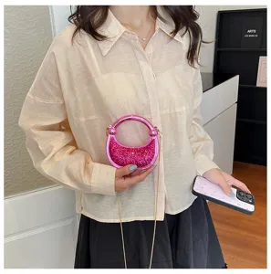 Mini pink glitter acrylic evening bag with metal chain handle, stylish detail view.