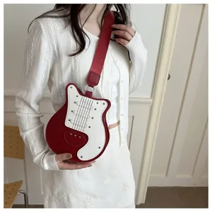 Detail view of the guitar shaped crossbody bag featuring red white color blocking and metal studs.