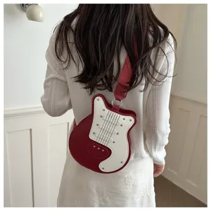 Guitar shaped crossbody bag detail showcasing unique red white color block design with rivets.