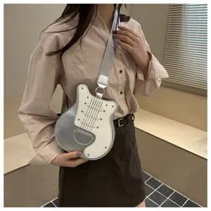 Guitar shaped crossbody bag for women, unique silver white design with rivets and shoulder strap.
