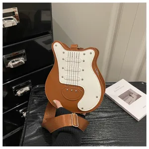 Close-up detail of unique guitar shaped shoulder bag, brown white with metal rivets.