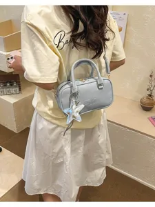 Spring women stylish blue bowling pillow bag detail view, trendy shoulder messenger bag with star charm.