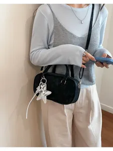 Black bowling shoulder bag for women, trendy PU leather pillow handbag with star charm.