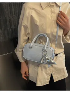 Light blue patent boston shoulder bag detail, stylish casual crossbody purse with star charm.