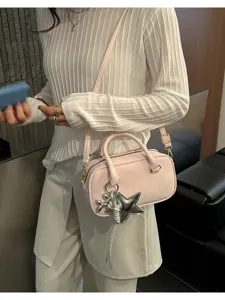 Pink bowling bag for women, stylish pillow shoulder bag with chic star charm and strap.