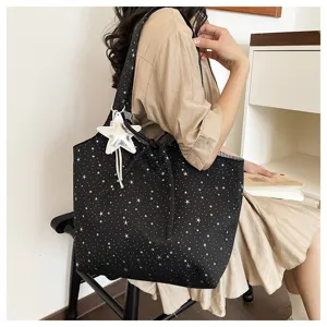 Casual black star print canvas shoulder tote bag with cute star pendant for daily commute.