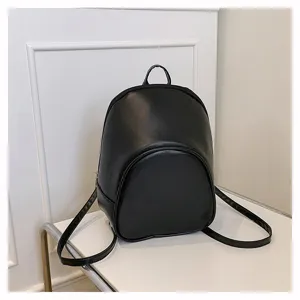 Close-up detail of black mini backpack, minimalist design for women commuting and daily use.