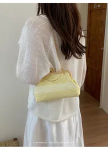 Retro stripe kiss-lock shoulder bag, premium yellow fabric with gold chain strap detail.