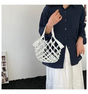Detailed view of the white leather mesh handbag, featuring a unique woven folding design.