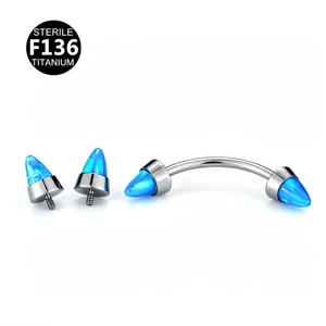 Titanium curved barbell piercing with blue opal spike ends for eyebrow, ear and nose.