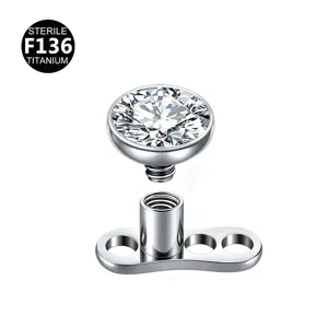 Titanium dermal anchor piercing top with sparkling rhinestone, medical grade body jewelry detail.