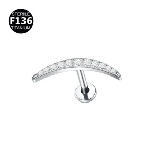 Titanium curved crescent moon labret stud detail shot with sparkling clear cubic zirconia stones.