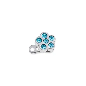 Close-up detail of sparkling blue cubic zirconia flower microdermal piercing top in steel.