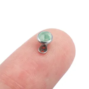 Titanium microdermal piercing top detail view, green stone dermal anchor accessory.