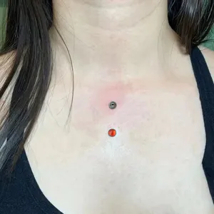 Detail shot of F136 titanium 4mm dermal piercing replacement top body jewelry.