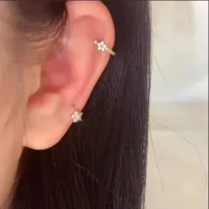 Stainless steel micro-pave zircon flower ear cuff and stud detail shot showing elegant wearing style.