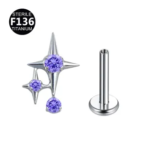 Gioiello piercing stella in titanio F136 con zircone viola e filettatura interna.