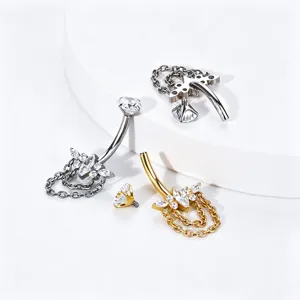 Close-up detail of titanium alloy navel piercing with butterfly zircon crystals and chains.