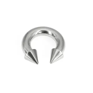Titanium curved barbell piercing with sharp cone ends, ideal for body piercing detail.
