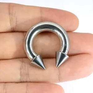 Large titanium horseshoe ring body piercing jewelry with cone ends for ear and septum piercing.