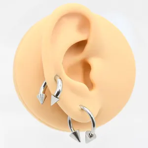 Close-up view of F136 titanium alloy horseshoe piercing rings featuring sharp conical ends.