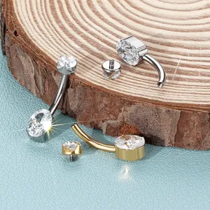 Titanium curved barbell navel ring detail showing internal thread, cubic zirconia and metal shine.