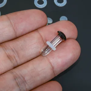 Clear glass ear stretching plug with black end and white silicone o-ring body jewelry.