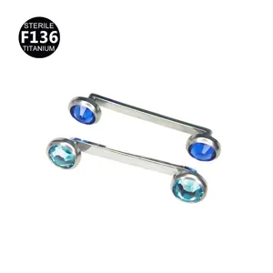 Titanium surface piercing jewelry with double blue crystal gems for body art.