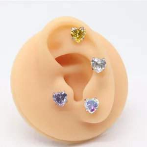 Detailed close-up view of colorful heart-shaped cubic zirconia piercing jewelry studs.