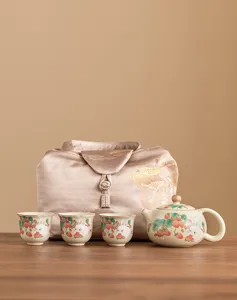 Ceramic kung fu tea set with one teapot and three cups, featuring cute strawberry rabbit pattern.