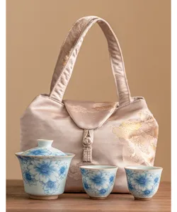 Blue and white ceramic kung fu tea set with gaiwan, teacups, and portable fabric storage bag.
