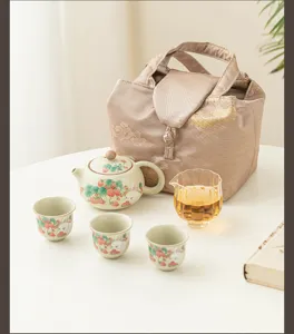 Strawberry rabbit ceramic kung fu tea set with teapot, cups, and portable storage bag.