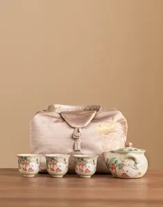 Detailed view of ceramic teapot set with cute rabbit and strawberry illustration on wooden table.