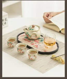 Detailed view of the cute strawberry rabbit ceramic kung fu tea set, including teapot and cups.
