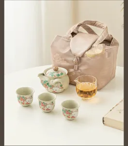 Detail view of cute strawberry rabbit ceramic tea set with teapot and three cups for home use.