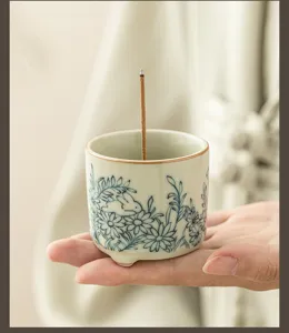 Ceramic rabbit incense holder detail, blue and white flower pattern, small ornament decor.