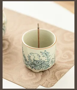 Handmade ceramic incense burner featuring cute rabbit and flower design for home tea decor.