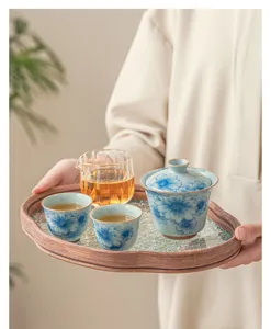 Chinese ceramic kung fu tea set with blue and white sunflower pattern, gaiwan, cups and glass tray.