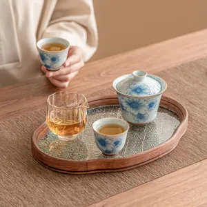 Blue and white ceramic Kung Fu tea set with gaiwan, teacups, and glass tea tray for home.