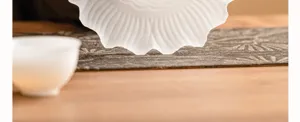 Frosted glass lotus shaped teapot holder detail shot, elegant tea tray base for home daily use.