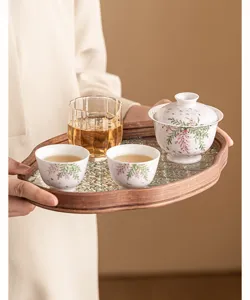 Detail shot of the handpainted wisteria Kung Fu tea set with ceramic cups and wooden serving tray.