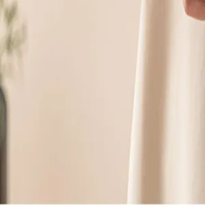 Detailed view of the smooth beige fabric showcasing fine texture and elegant neutral tone.
