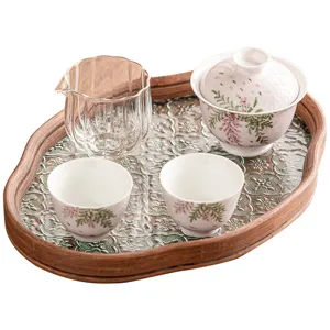 Hand-painted wisteria kung fu tea set with ceramic gaiwan, cups, pitcher, and glass tea tray.