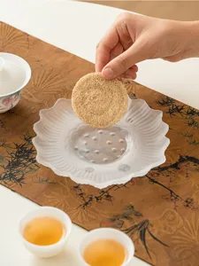 Frosted glass lotus tea tray coaster and plant fiber mat, elegant Chinese style tea table decor.