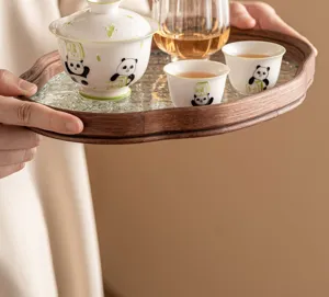 Detailed view of cute panda ceramic tea set with wooden glass tray for traditional kung fu tea.