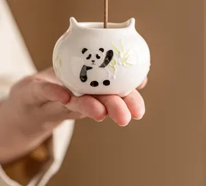Handmade ceramic panda incense burner detail shot, cute animal incense holder for home.