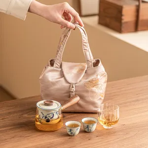 Portable Kung Fu tea set with hand-painted panda teapot, two cups, and a stylish travel bag.