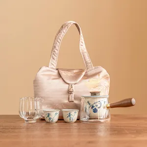 Portable ceramic Kung Fu tea set with hand-painted panda teapot, two cups, and travel bag.
